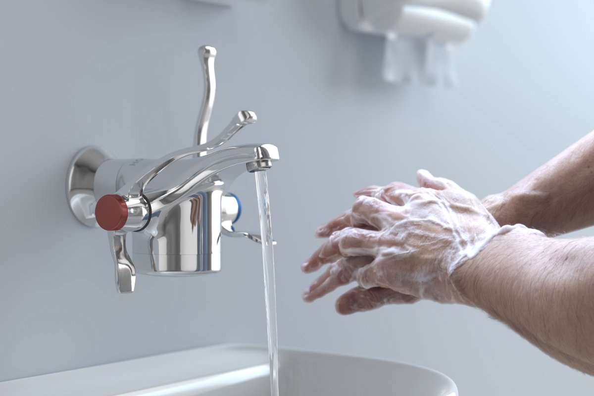 Handwashing under thermostatically controlled warm water - Horne Optitherm thermostatic tap