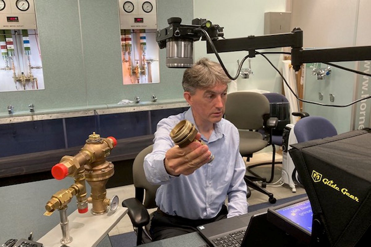 Zoom-in maintenance training: John Horne holds the Horne 40 valve cover assembly up to the overhead camera
