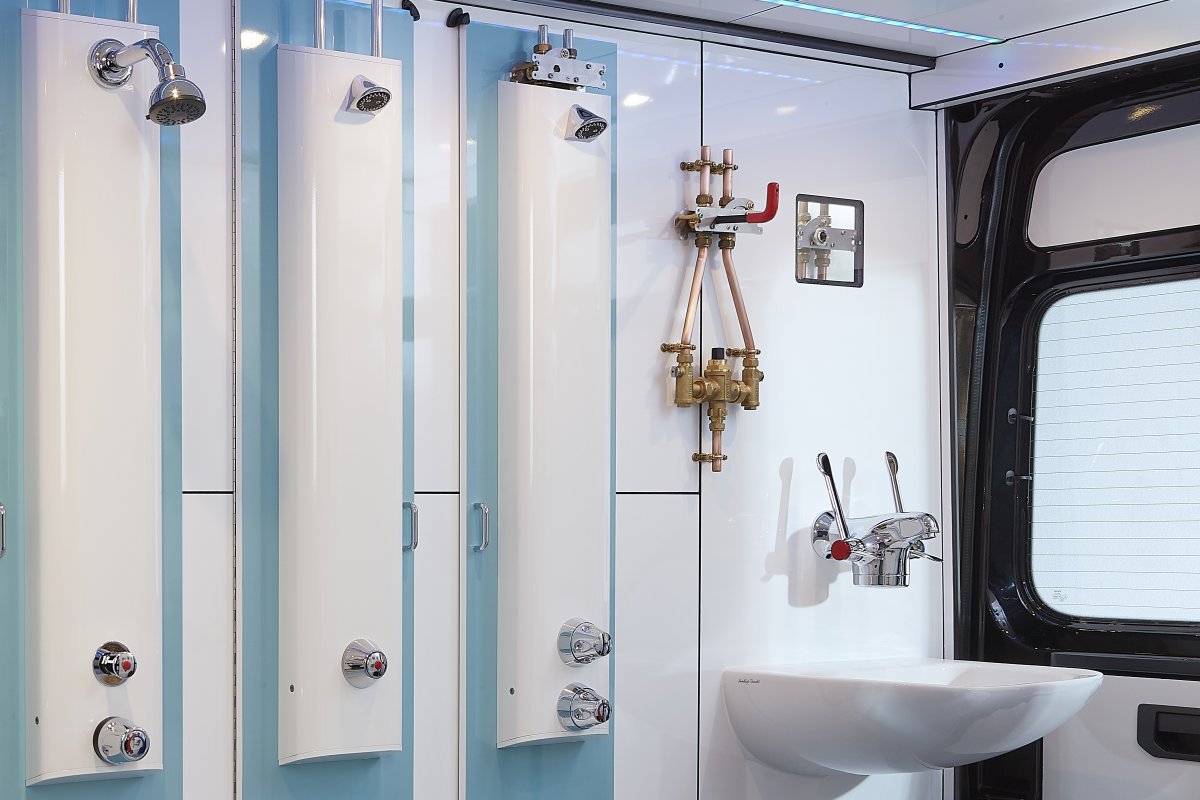 Horne pre-plumbed shower panels, Optitherm thermostatic clinical tap, Horne 15 thermostatic mixing valve and ILTDU, in-line thermal disinfection unit, on display in the Horne Roadshow exhibition van